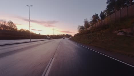 driving pov: fall morning commute on highway leading into city