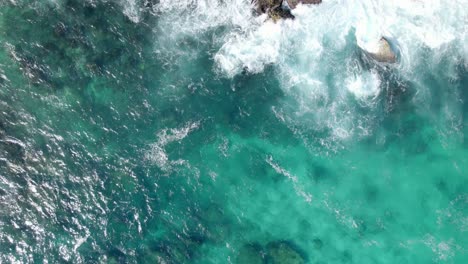 crystal clear with foamy waves on the rock shore of porte d'enfer, caribbean sea, guadeloupe, france