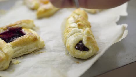 someone is putting icing on a freshly baked pastry