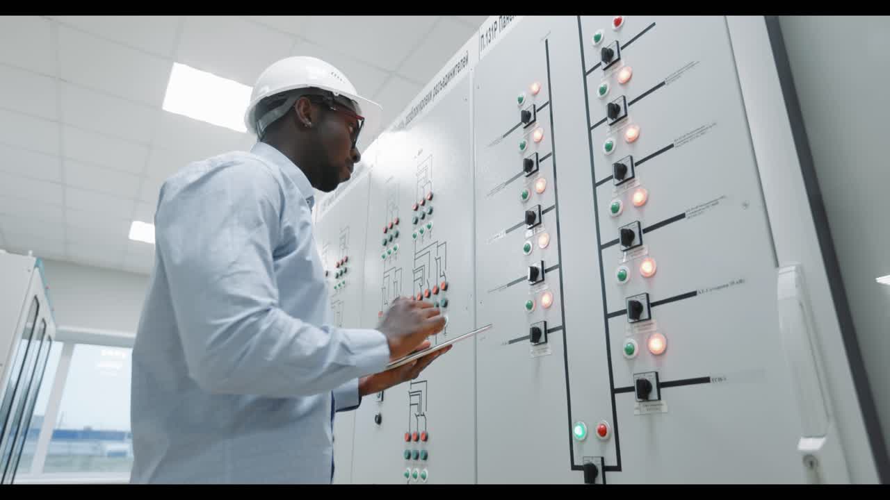 Engineer Working on Control Panel in Power Plant