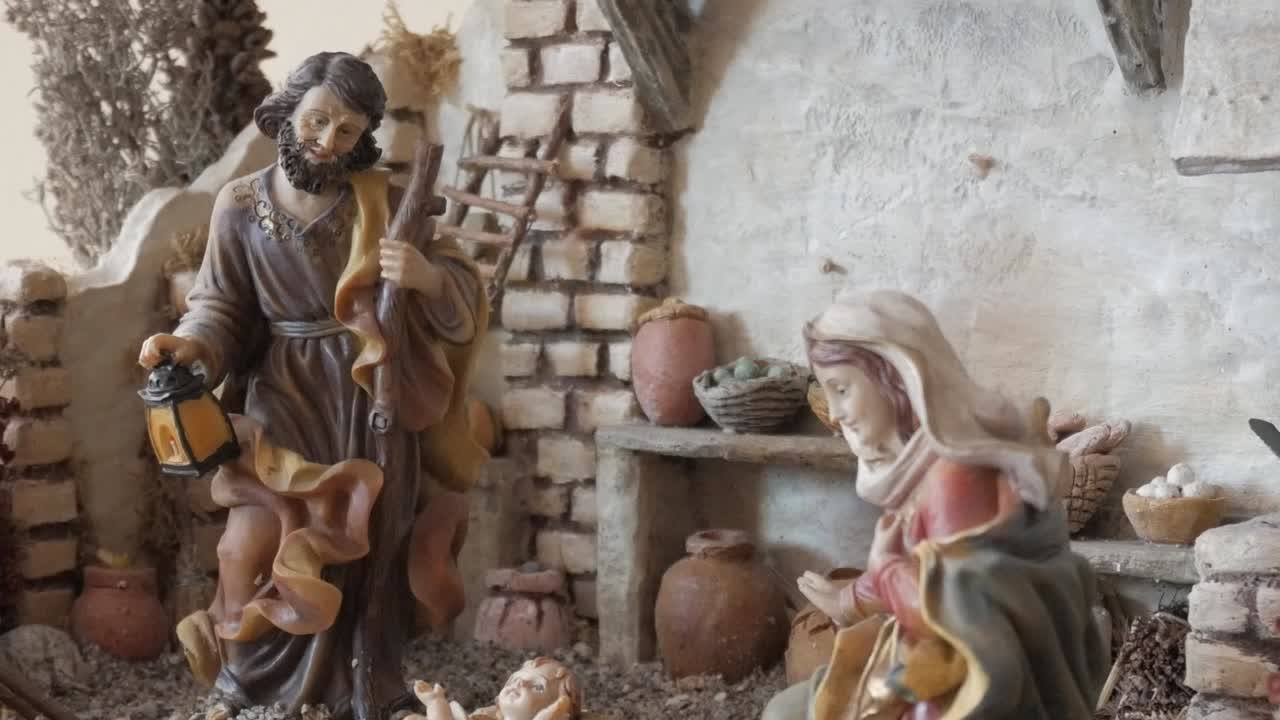 A serene nativity scene depicting Joseph holding a lantern and Mary kneeling indoors