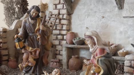 a serene nativity scene depicting joseph holding a lantern and mary kneeling indoors