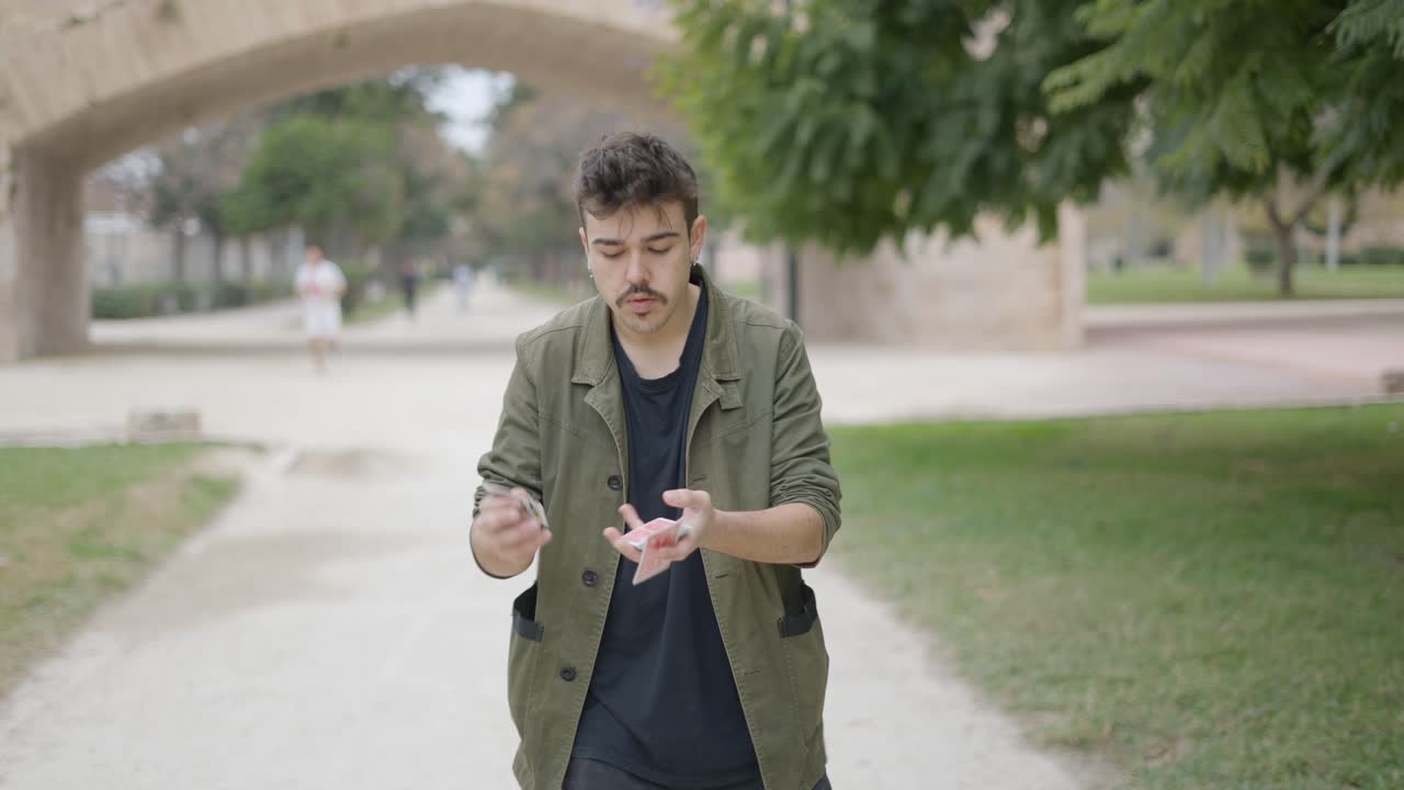 Street Magician Performing Card Tricks