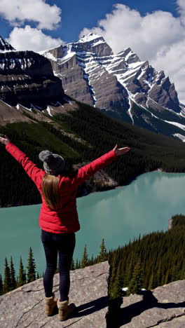 woman enjoying the view of a mountain lake in the canadian rockies