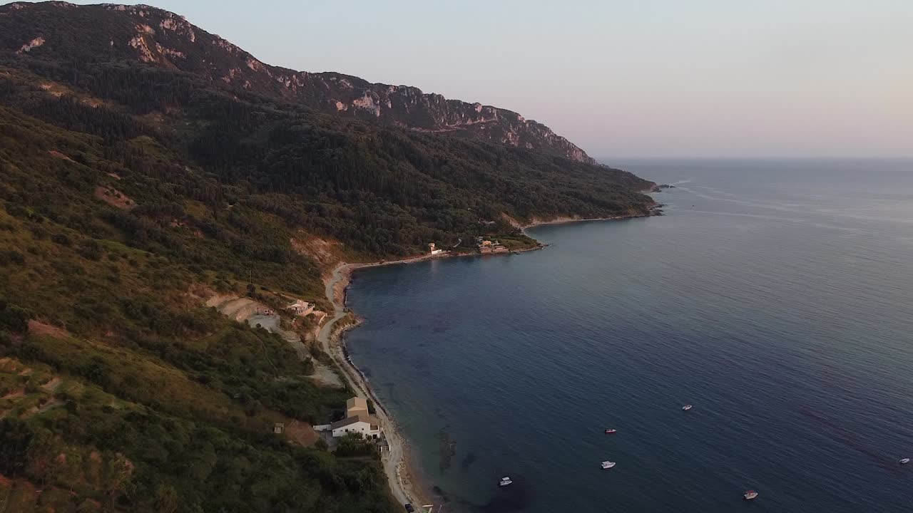 Flight over blue corfu bay, wild beach, sand and boats