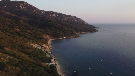 Flight-over-blue-corfu-bay,-wild-beach,-sand-and-boats