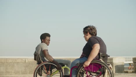 Happy-couple-dancing-using-wheelchairs-at-quay