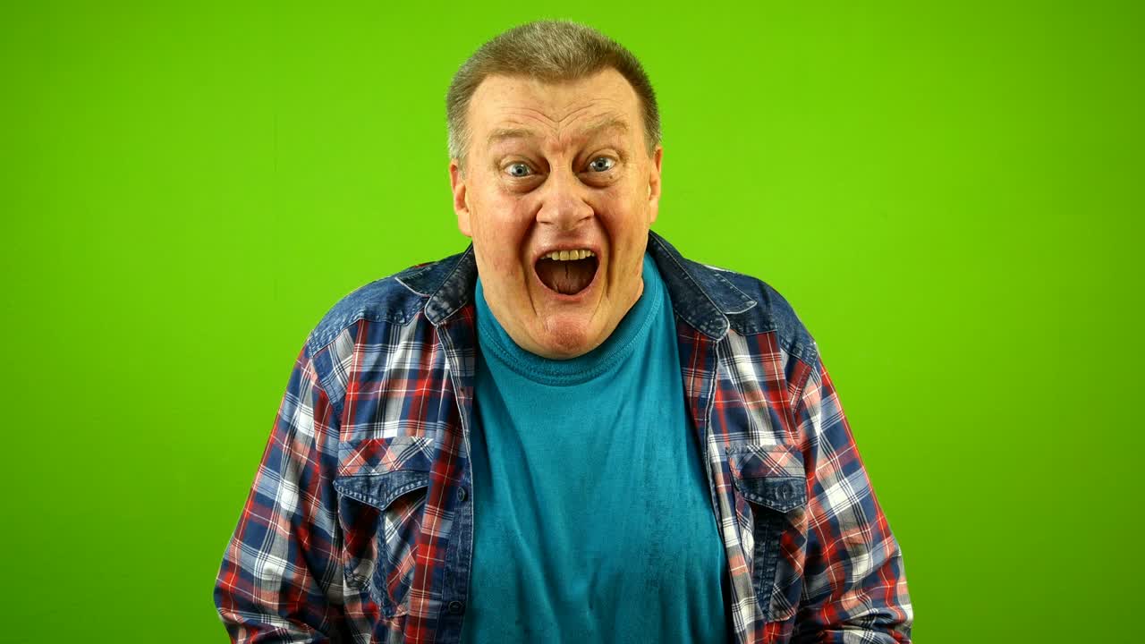 Upset elderly caucasian man feels horror hopelessness screaming and shouting, saw something terrible. Feels depression, fear.