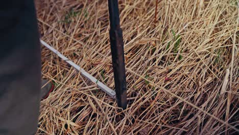 man digging holes for building traditional fence - close up