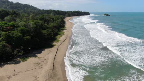 costa rica beach drone view showing sea, shore and forest