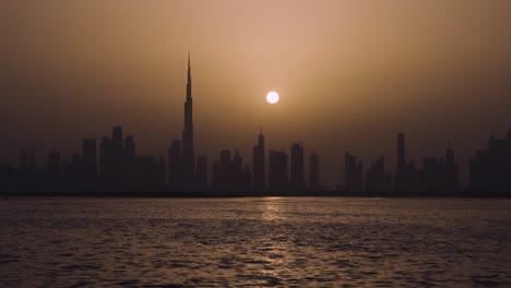 calm evening view of dubai business district by the bay in united arab emirates - wide shot