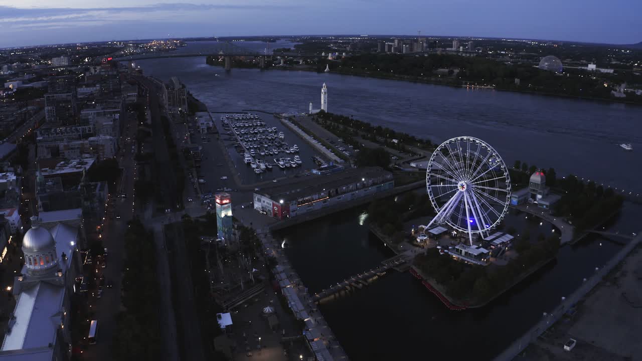 Aerial shot of Montreal's Old Port with the Ferris wheel in view, showcasing the vibrant waterfront and historic architecture. Perfect for capturing the essence of the city.