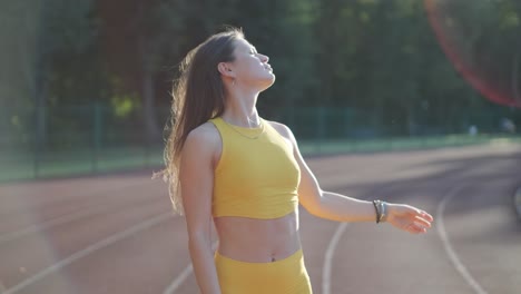 woman running on outdoor track in yellow sportswear