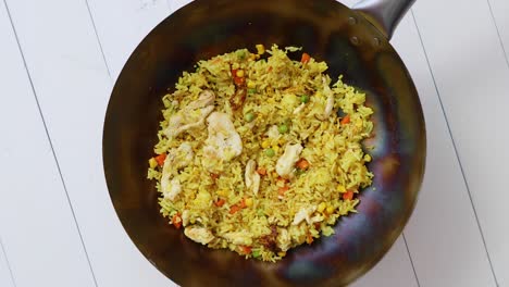 delicious thai dish in hot wok  fried chicken with rice and vegetables  spin 360  slow motion