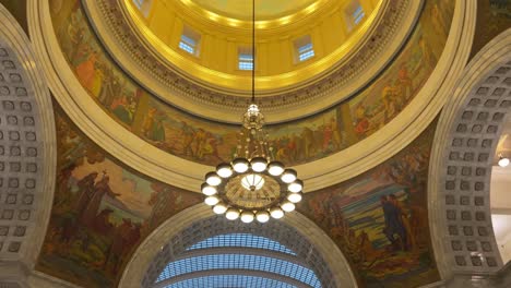 panning from left to right looking up at the murals and chandelier inside the utah state capital