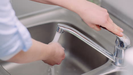 man washing hands in sink covid 19