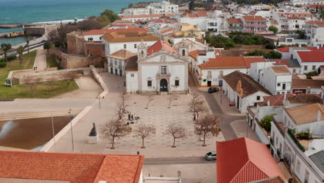 Pictoresque-aerial-drone-view-above-Lagos-sea-port-town,-Portugal,-forward,-sunny-day