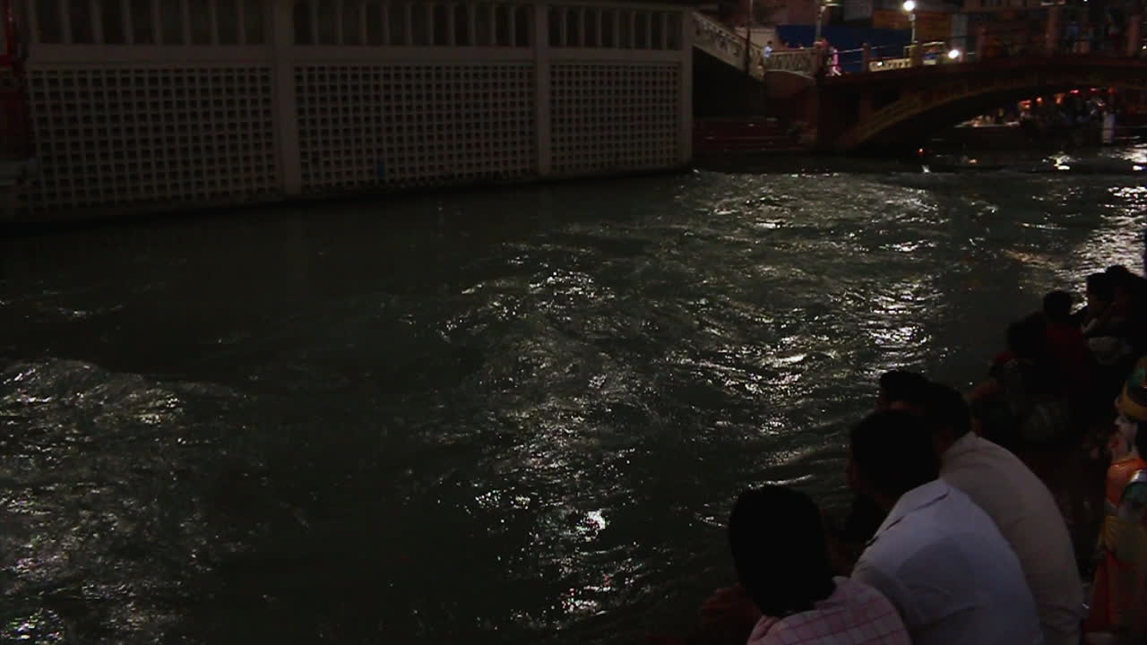 Massive flow of the Ganges river water in Haridwar, slow motion pan shot.