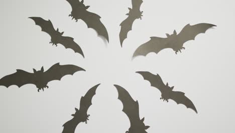 digital animation of multiple halloween bat icons against grey background