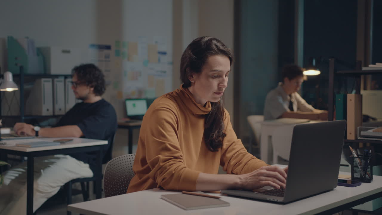 Young Businesswoman Working on Laptop Late in the Office