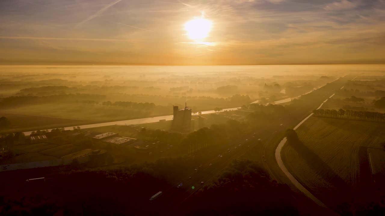 Sunrise Foggy Landscape Over Highway and Canal