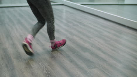 leg shot of dancer choreographer dancing freestyle shuffle in a dance studio