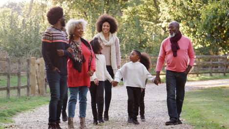 multi generation family on autumn walk in countryside together