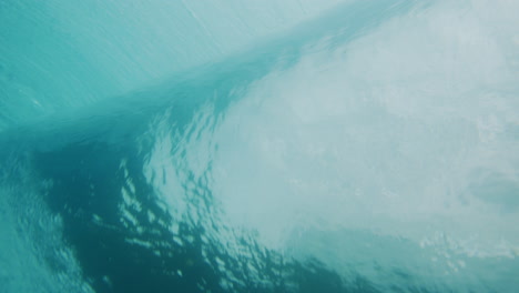 Barrel-picks-up-rising-into-vortext-capturing-whitewash-and-cloudy-sky-behind-clear-water