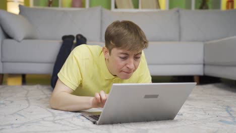 el joven hace una operación incorrecta en la computadora portátil en casa.