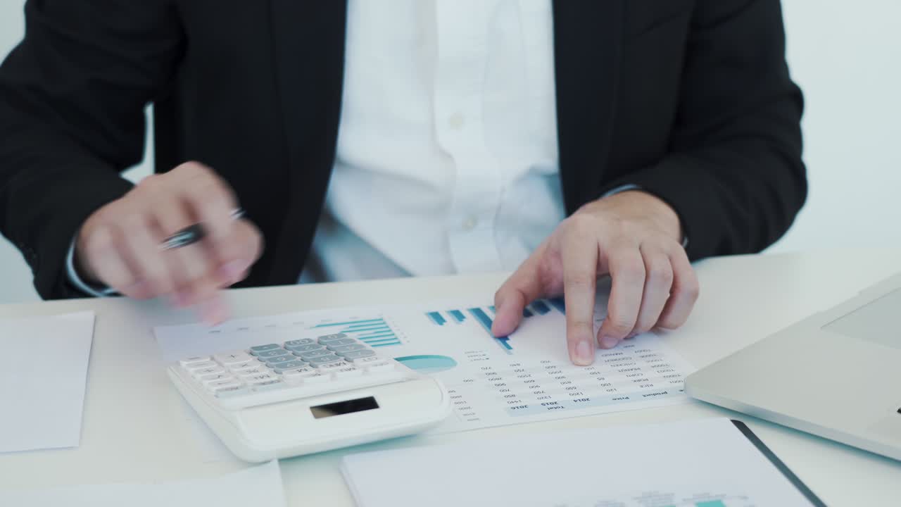 Businessman working with calculator.