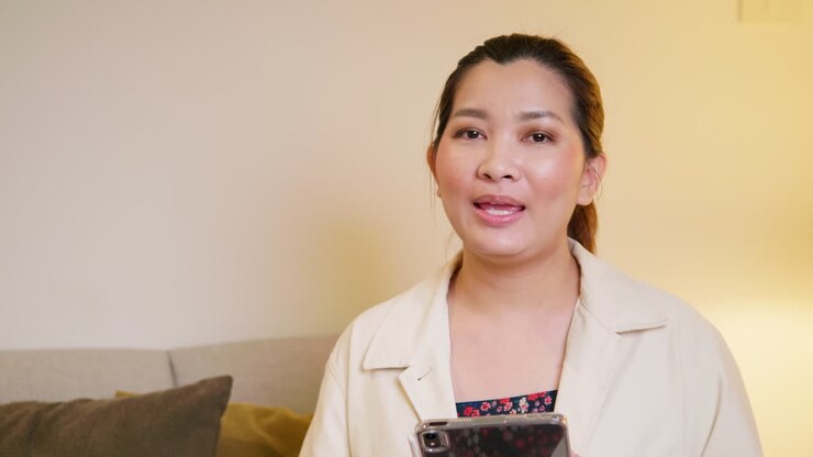 Young adult woman explaining and interview video online communication with casual clothing and speaking in room