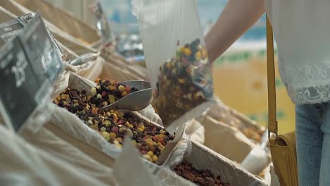 Young-girl-pours-dried-fruit-into-a-package