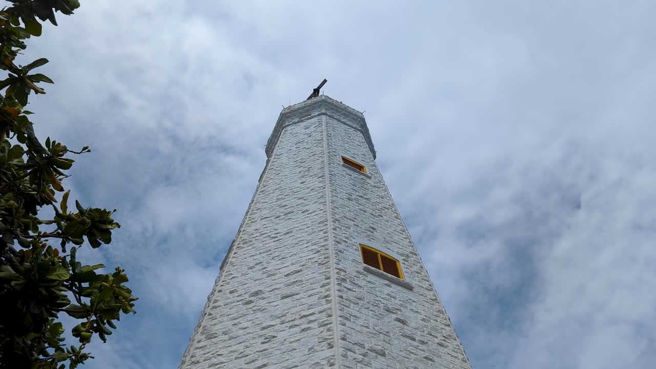 Pan up of Dondra Head Lighthouse building at southernmost point in Sri Lanka