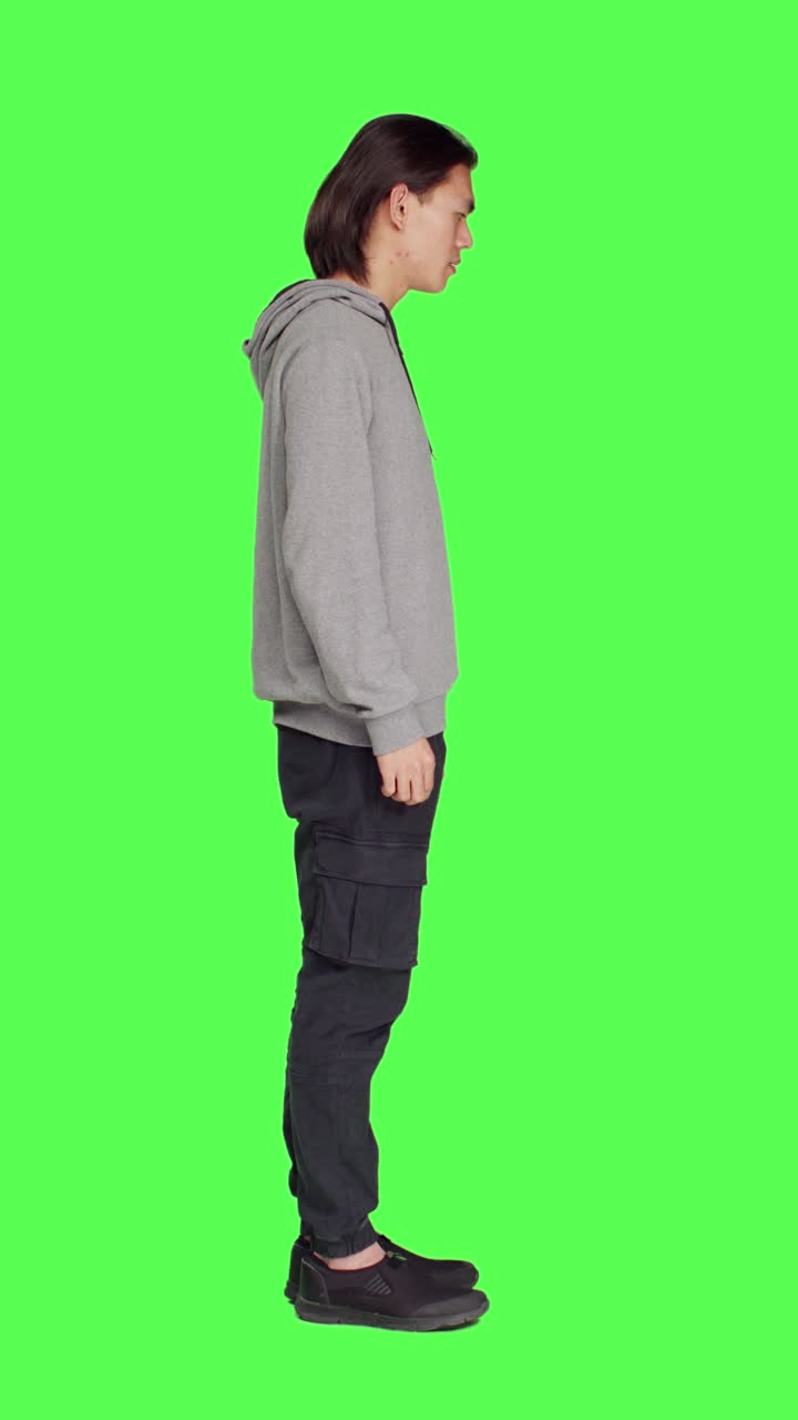 Profile of asian proud person standing in studio