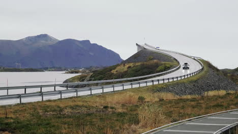 car driving down at the atlantic ocean road of county road 64 in more og romsdal county, norway