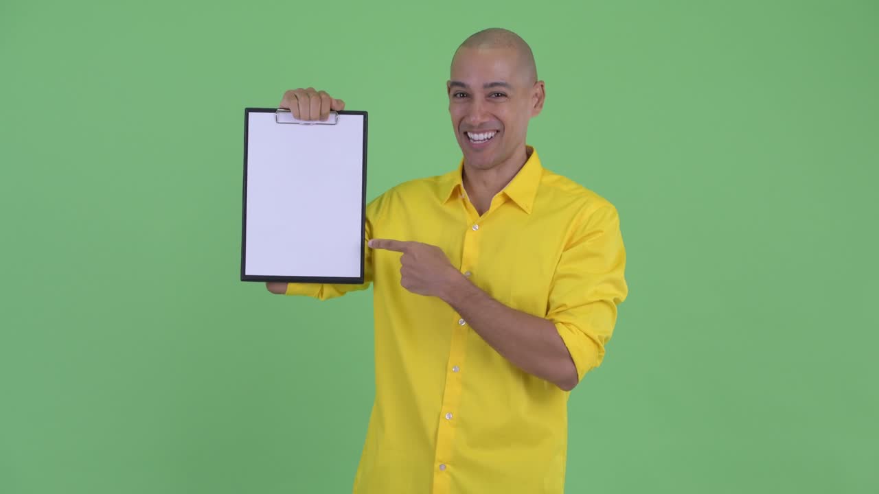 Happy handsome bald businessman showing clipboard