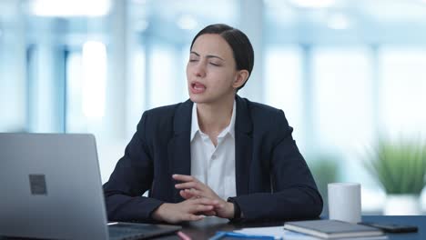 serious indian female manager talking to employees