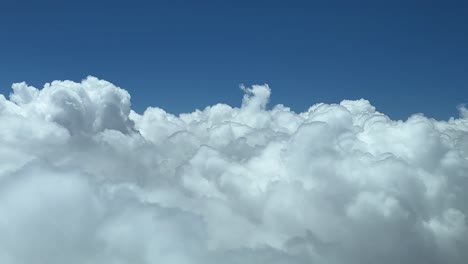 flight along white fluffy clouds in the sky