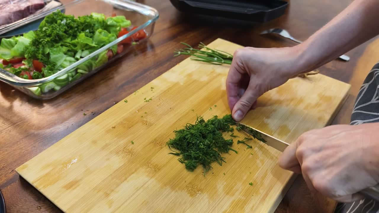 Preparing a healthy salad with fresh herbs and vegetables