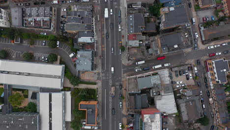 Aerial-birds-eye-overhead-top-down-vertical-panning-view-vehicles-driving-in-city.-Traffic-in-urban-neighbourhood.-London,-UK