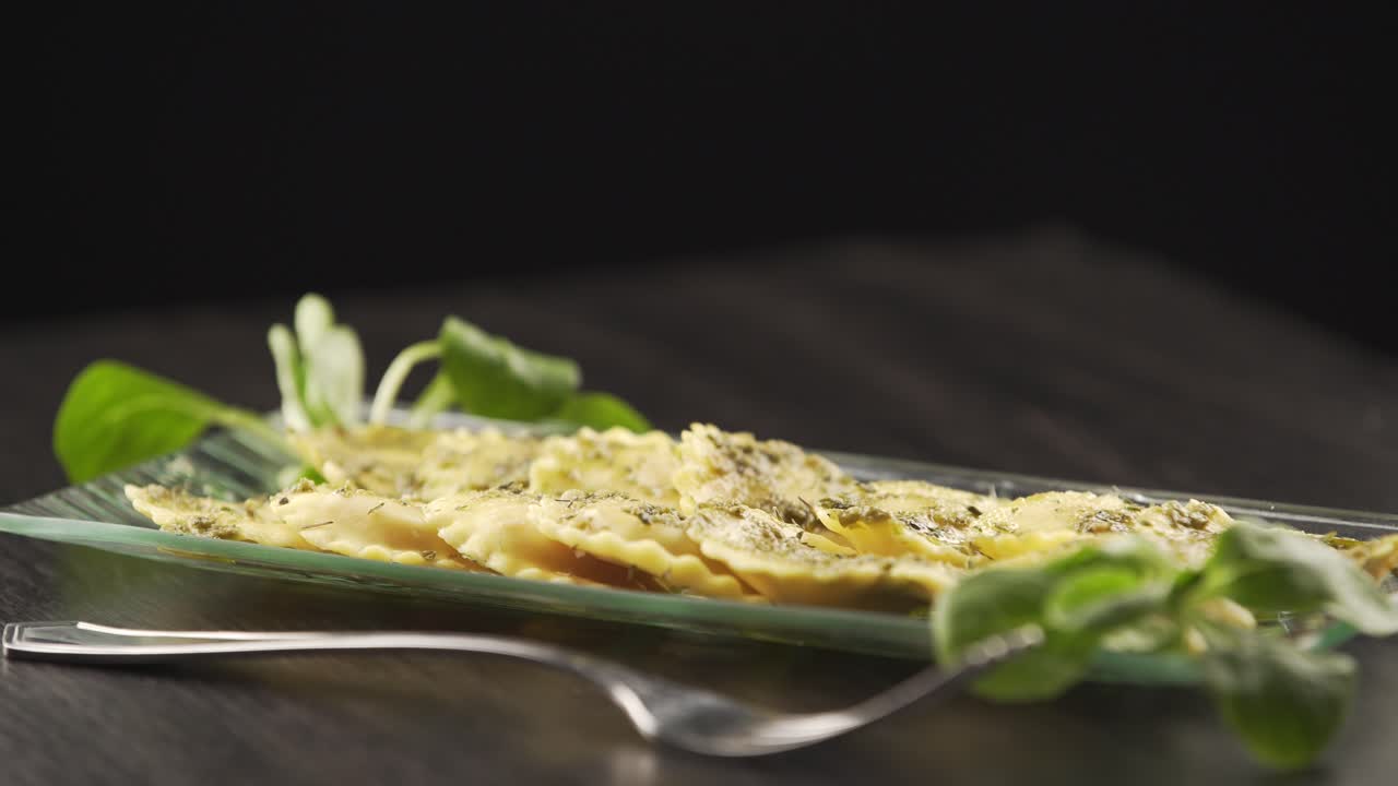 A cook finishes decorating the perfect dish for his gourmet kitchen. Concept of: food, cuisine, chef, gourmet, artist