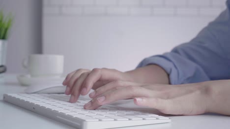 beautiful young smiling asian woman working on laptop while sitting in a living room at home. asian business woman working in her home office. enjoying time at home.