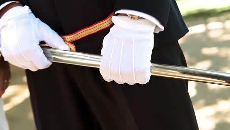 Military-Groom-Wearing-White-Gloves-Holding-Beautiful-Sword-Near-His-Bride