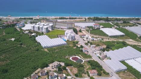 aerial view of coastal resort town with greenhouses