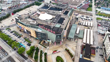 aerial view of the largest glass shopping mall in danyang, jiangsu province, china, showcasing its expansive layout and modern architecture amidst bustling urban surroundings.