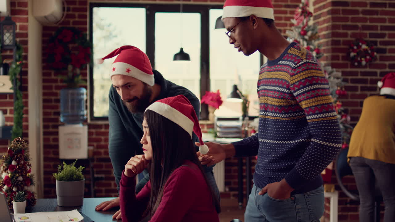 Diverse coworkers working on startup report in festive office