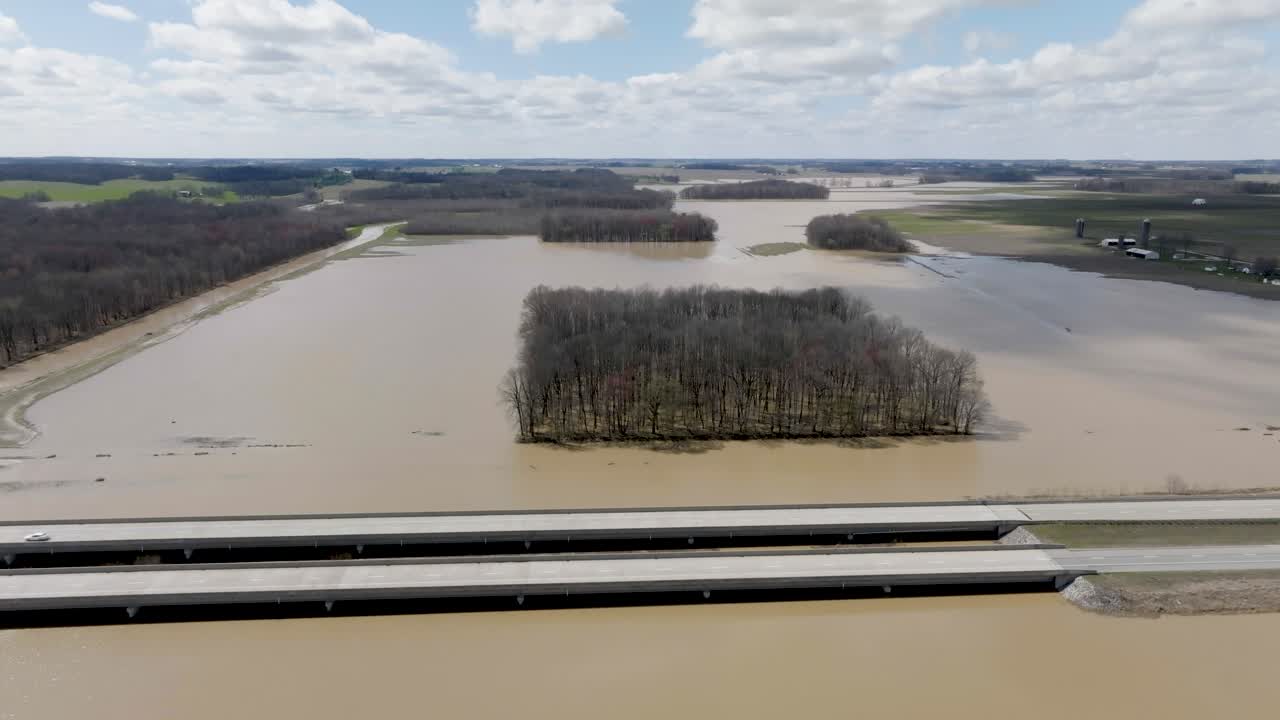 Flooded area in southern Indiana farmland next to freeway with drone video wide shot moving forward