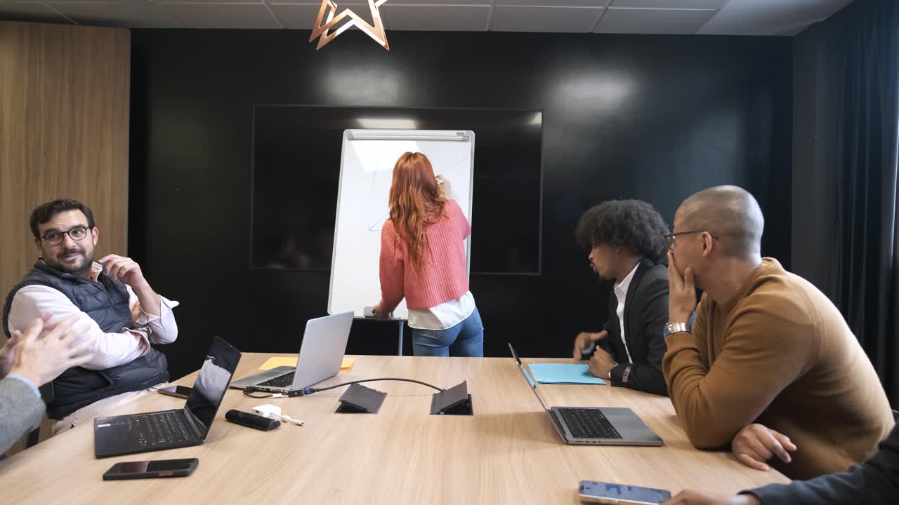 Businesspeople discussing during presentation in creative office