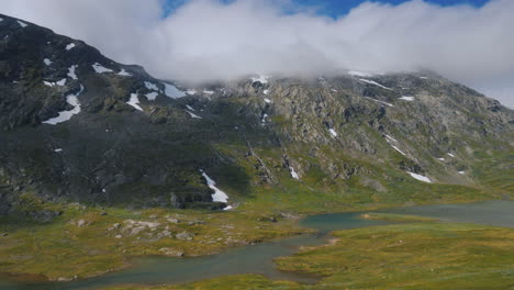 ride near the picturesque mountain landscape of norway drive past a lone wooden house view from car