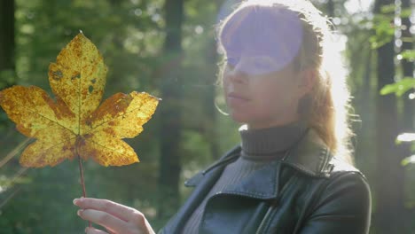 stunning scene as girl admires gold leaf twirling in fingers, lens flare